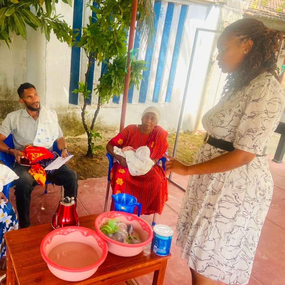 Kulea Villages social worker teaches a caregiver how to prepare infant formula.