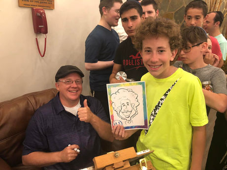 mark and a kid posed with his caricature