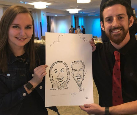 a couple holding their caricature between them