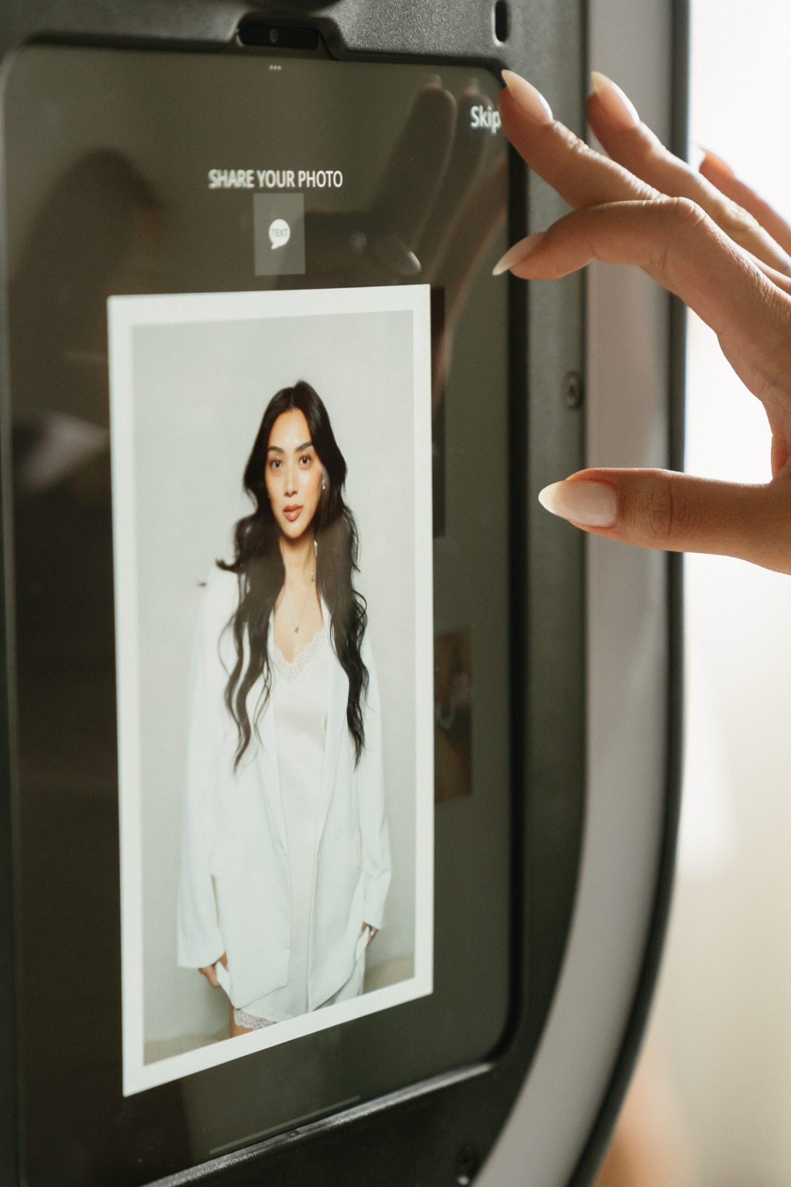 Guest sharing photos instantly from a digital photo booth at a San Antonio event