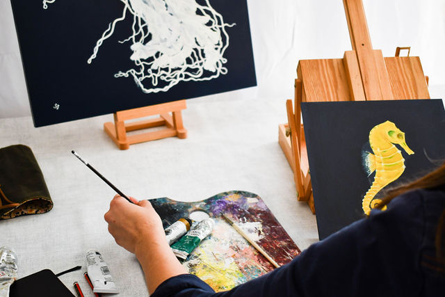 Business owner painting during her brand photoshoot in Devon