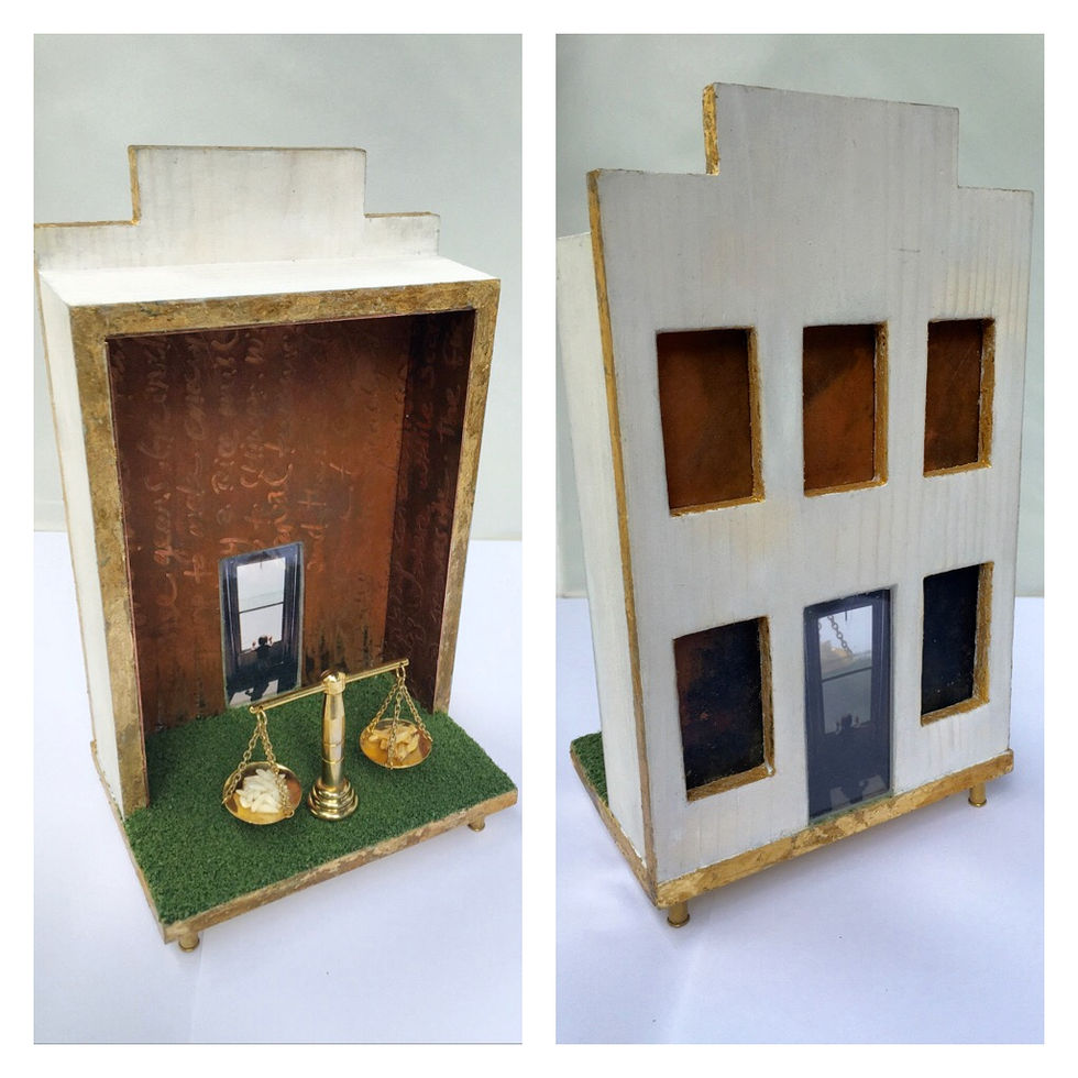 Photograph of miniature house and a set of justice scales.