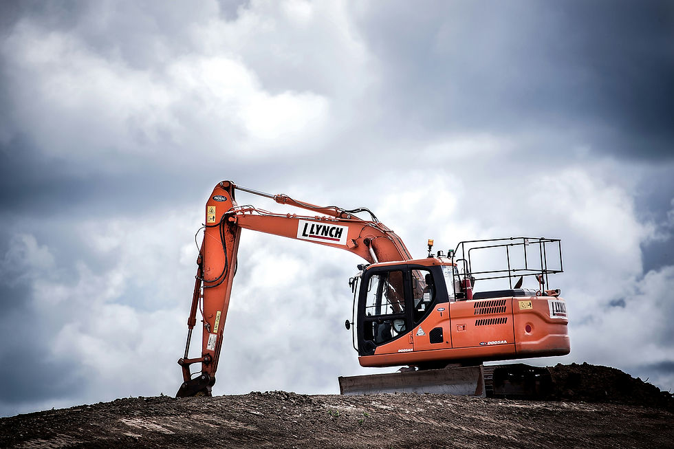 A digger at the top of a pile of soil