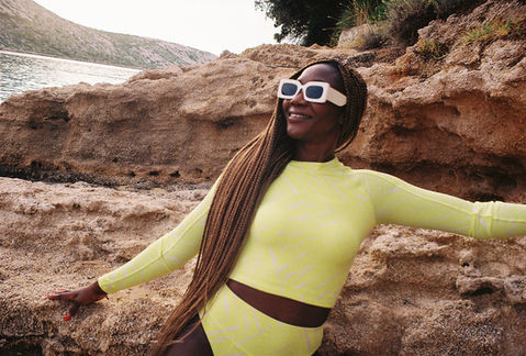 Woman in yellow athletic wear against desert rock formations, Croatia
Alt: Lifestyle portrait woman yellow outfit desert rocks Abu Dhabi — commercial lifestyle photographer Andie Szatmari