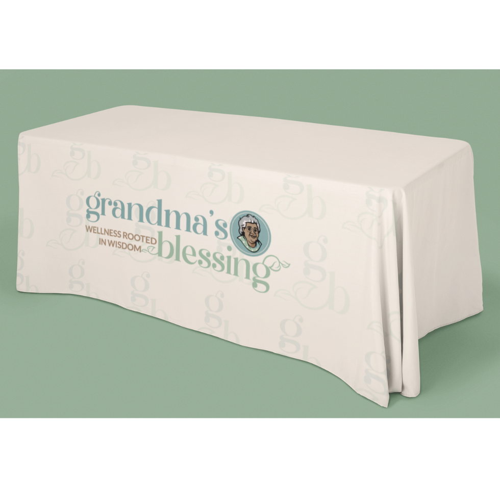 Cream tablecloth with centered Grandma’s Blessing logo in earthy tones.
