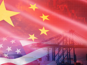 American and Chinese flags waving near a busy international shipping port, symbolizing global trade relations and tariff tensions.