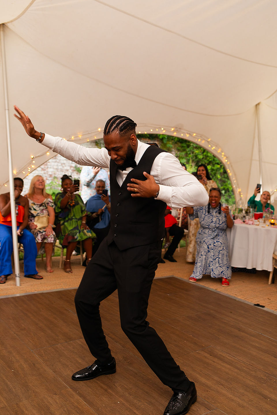 Groom dancing in the wedding marquee