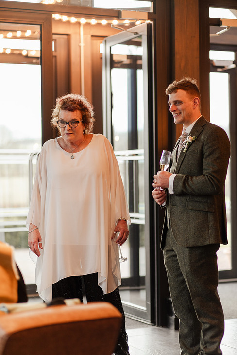 Groomsmen talking with wedding guests