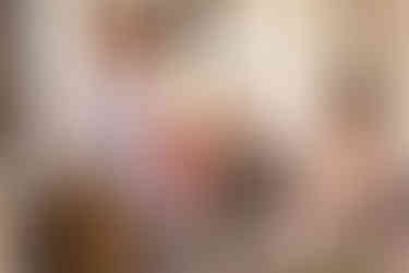 Waitress pouring champagne for the bride and groom