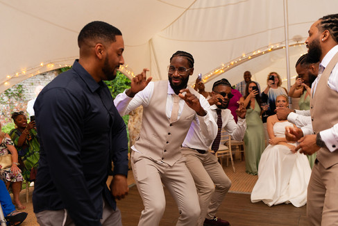 Guests dancing together in the wedding marquee.