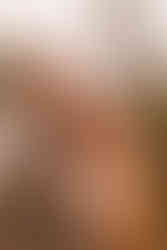 The bride smiles as the groom pulls her close.