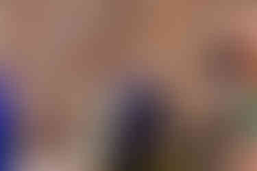 Guests posing for a photo that another guest is taking.