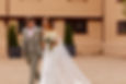 Bride and groom walk together holding hands