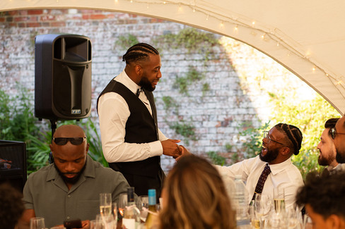 Groom and his bestman shake hands.