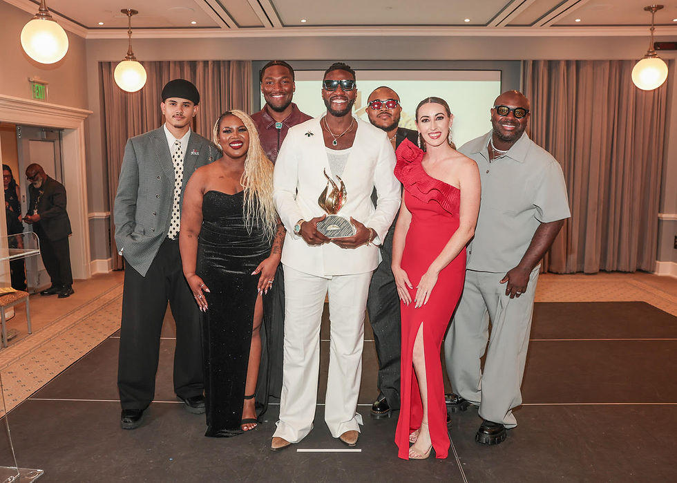 Transformation Worship poses elegantly at a formal event, with one person proudly holding an award trophy, celebrating their achievement in style. (photo courtesy of Central City Productions)
