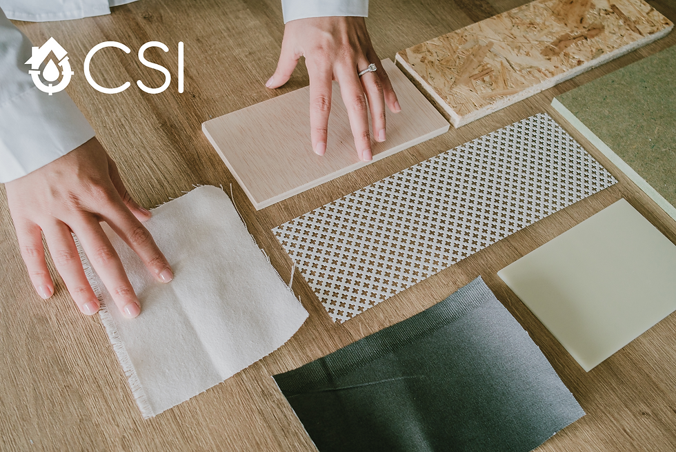 A hand holding stylish tiles with colorful wallpapers displayed on a table,