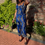 Thumbnail: Model showcasing vibrant African print corset Top in sunny outdoor setting