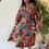 Thumbnail: Fashion model in a unique African print wrap dress, featuring intricate patterns and styles