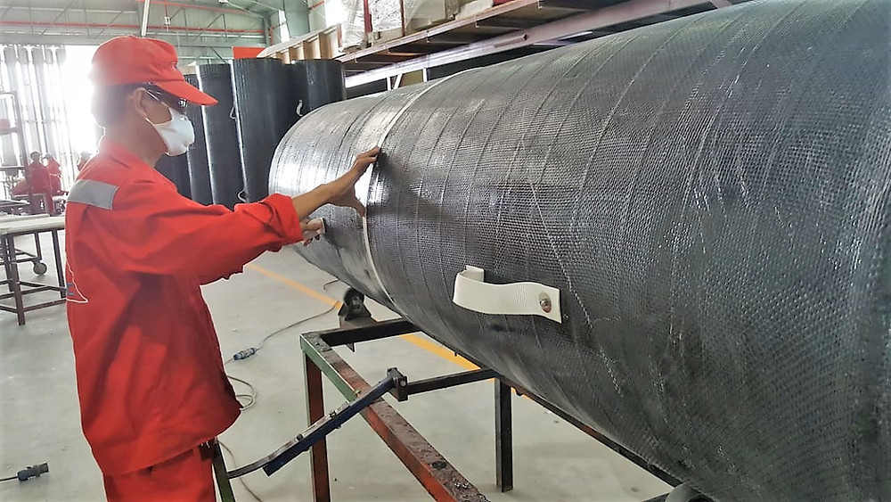 Adding the finishing touches to the carbon fiber ventilation tubes. The tubes are manufactured by Triac Composites.