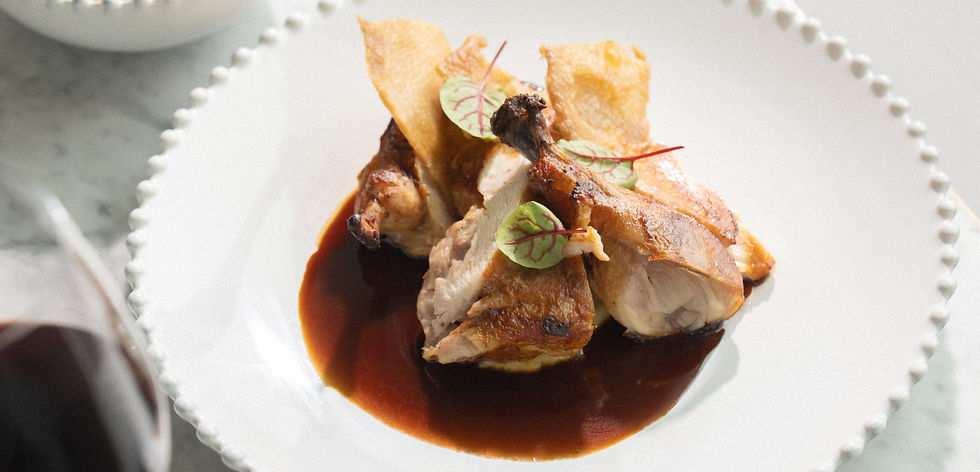 Roasted chicken with dark sauce on a white plate
