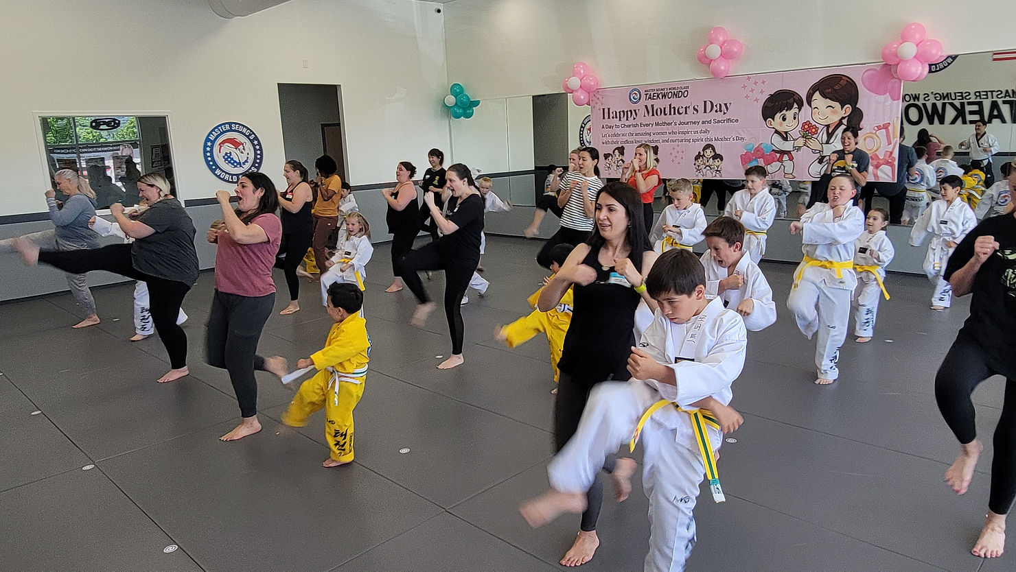Eye-level view of a Taekwondo dojang with students practicing kicks