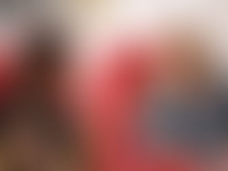 Two women sitting on red chairs