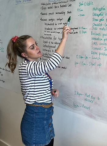 Young professional writing on a white board