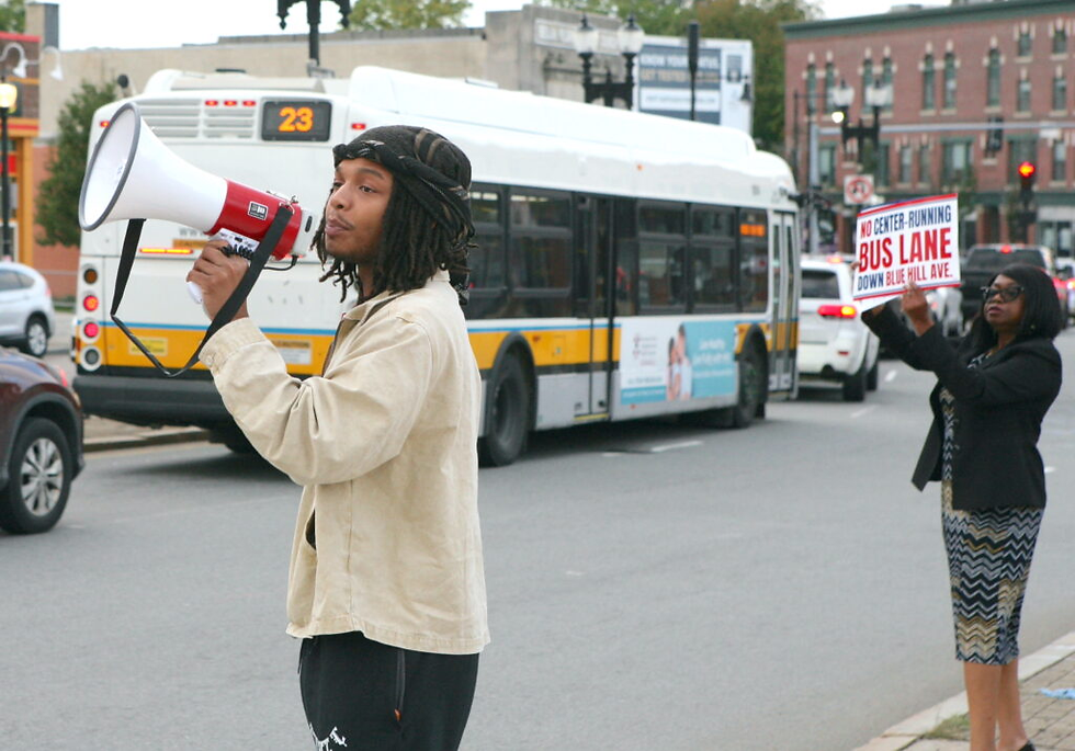 West Ward called for “No Center Bus Lane” during a rally of opponents in Grove Hall’s Mecca plaza ahead of the official meeting. Seth Daniel photo