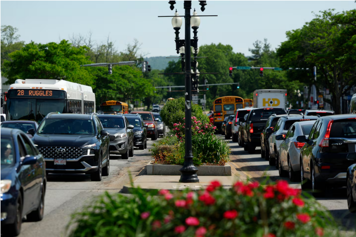 Afternoon rush-hour traffic moved along Blue Hill Ave in Mattapan in June. DANIELLE PARHIZKARAN/GLOBE STAFF