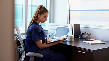 girl scrubs computer.png