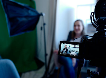 Photo of somebody recording a video of a woman on a camera | Daniel James Consulting | award-winning full-service consulting and creative agency