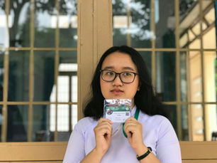 Young person holding an identification card