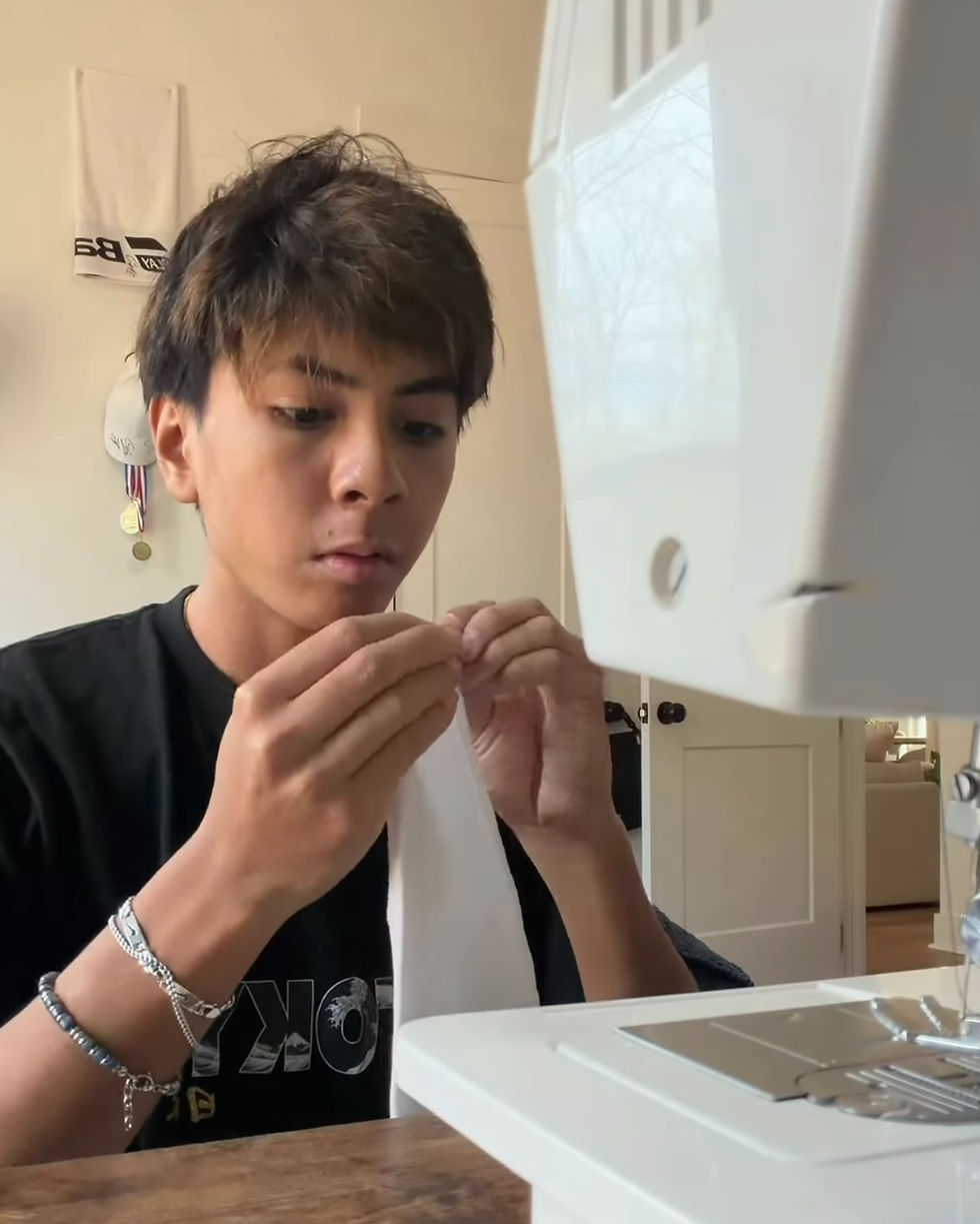 photo courtesy of Logan Xayaseng						Junior Logan Xayaseng puts together the waistband of a skirt that he is making for his sister, sophomore Lilly Xayaseng. He enjoys sewing because it allows him to relax after a busy day and creates an opportunity to make things for others.