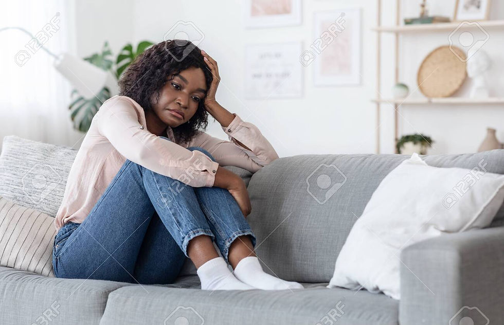 woman sitting on sofa, sad