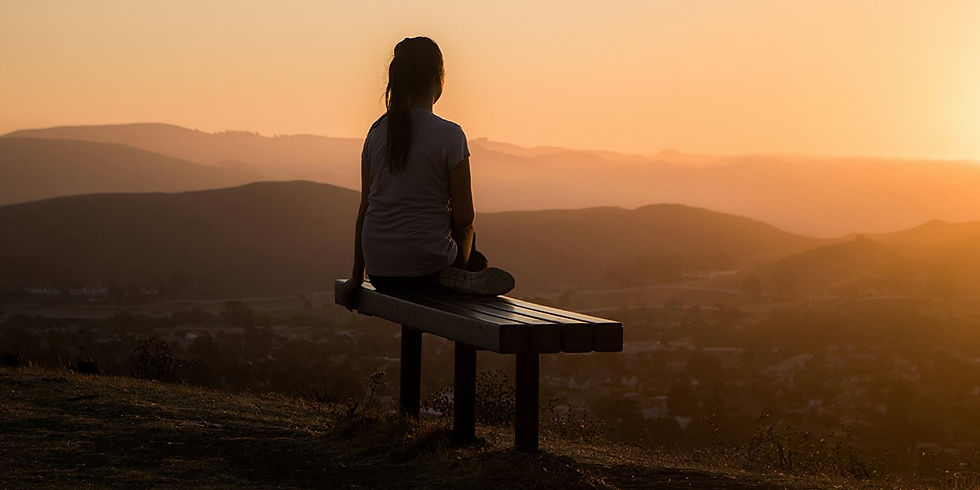 woman on bench on hill in early morning