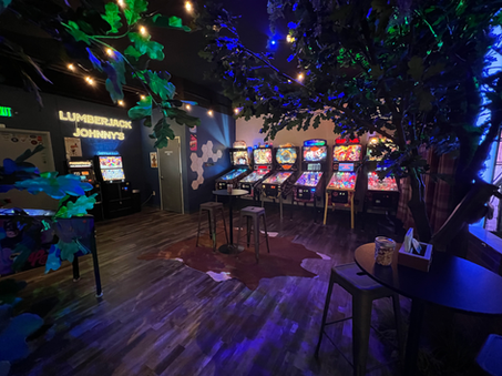 Zoomed out view of pinball machines in lounge area.