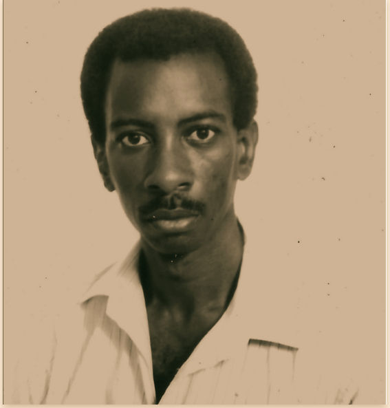 Headshot of Grahame Facey dressed in a white shirt against a plain background.