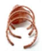 Handmade 99.99% pure copper bracelet displayed on a pink Strawberry Quartz crystal