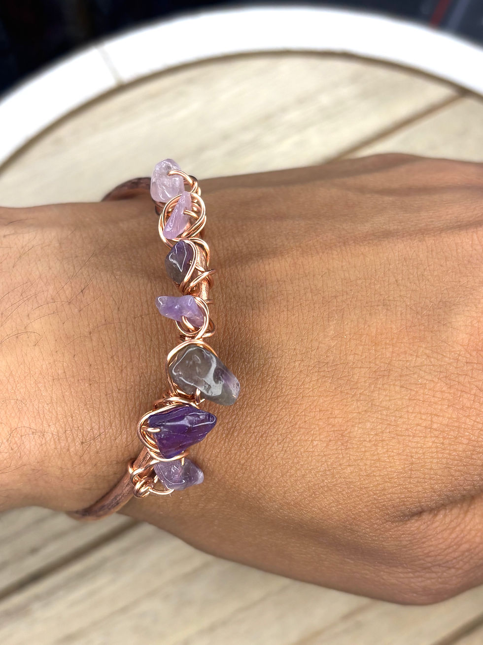 Copper amethyst cuff bracelet worn on wrist showing fit and stone detail