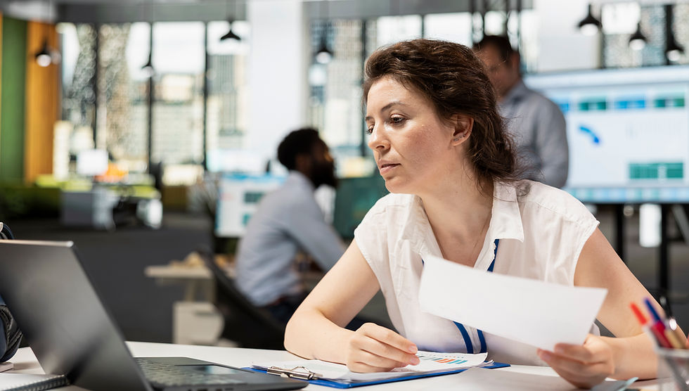 modern-office-focused-white-woman-comparing-company-data-laptop-document-female-analyst.jp