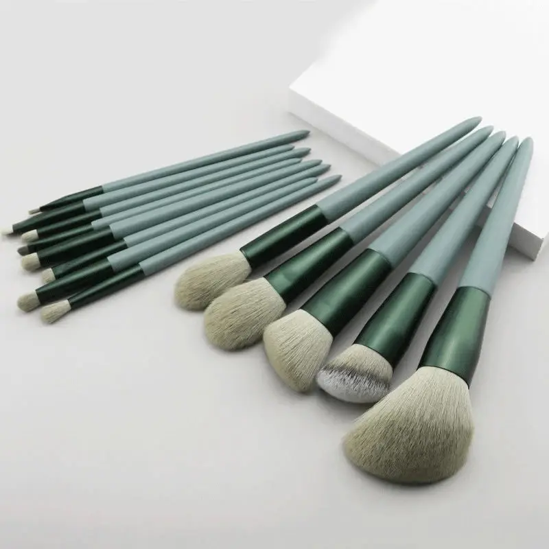 Thumbnail: Makeup brushes neatly arranged on white surface for beauty and cosmetics.