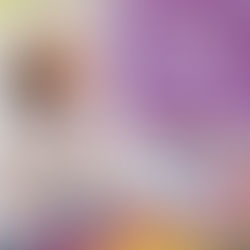 A young girl in a hospital bed laughing at something off camera.