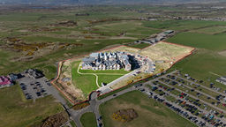 Drone view of a rural farmhouse with surrounding fields in Carmarthenshire.