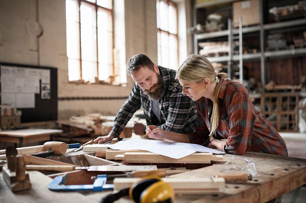 two-carpenters-man-and-woman-looking-at-blueprints-2026-03-10-03-14-23-utc.jpg