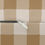 Thumbnail: Lumbar cushion with a classic caramel and ivory gingham check pattern on soft fabric.