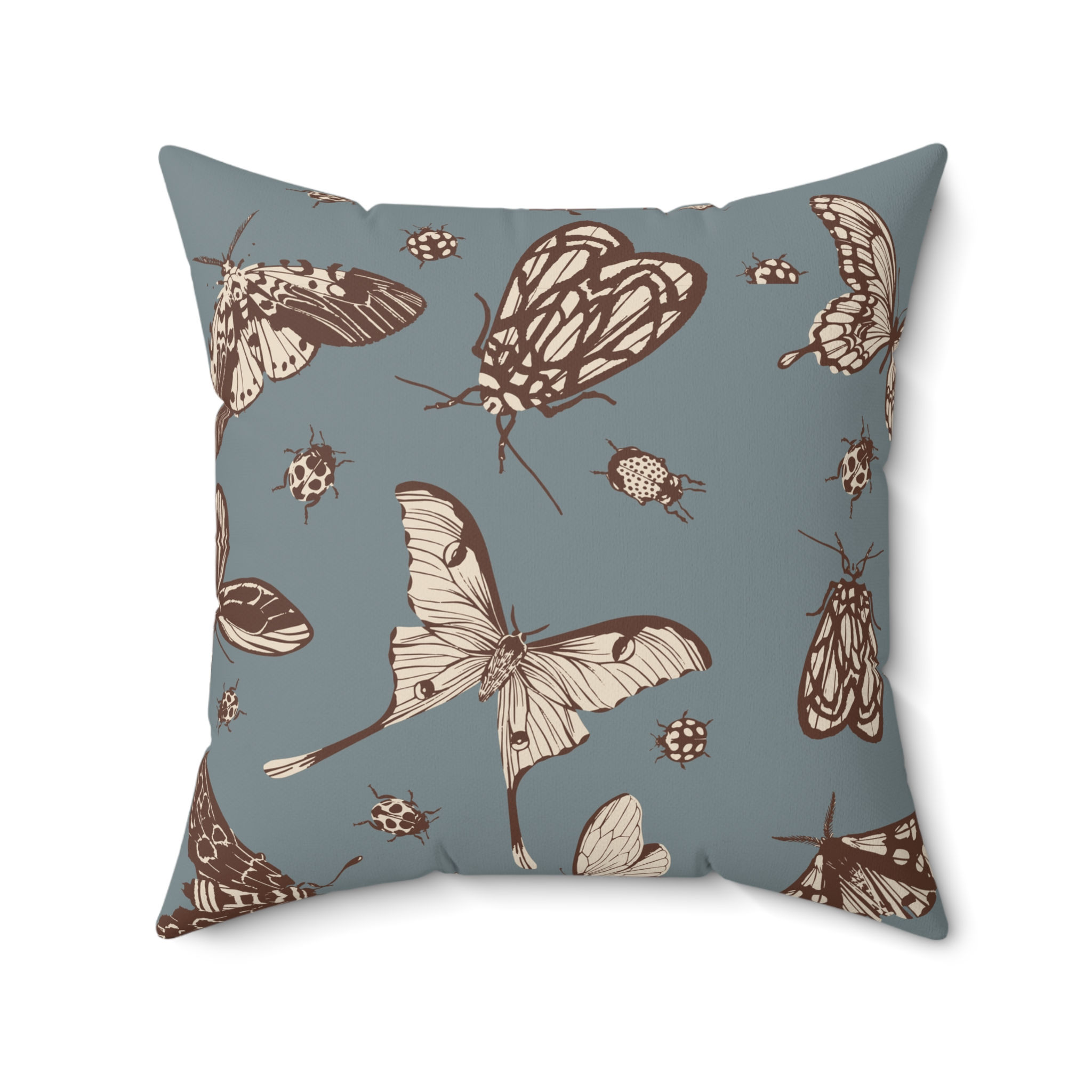 Decorative cushion with vintage-style insect illustrations in brown on a dusty blue background
