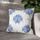 Thumbnail: Square throw pillow with blue floral motif patterns on a white background, ideal for elegant and modern home decor.