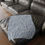 Thumbnail: Microfiber blanket with a soft blue background and white botanical leaf print, perfect for cozy home décor.
