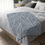 Thumbnail: Microfiber blanket with a soft blue background and white botanical leaf print, perfect for cozy home décor.