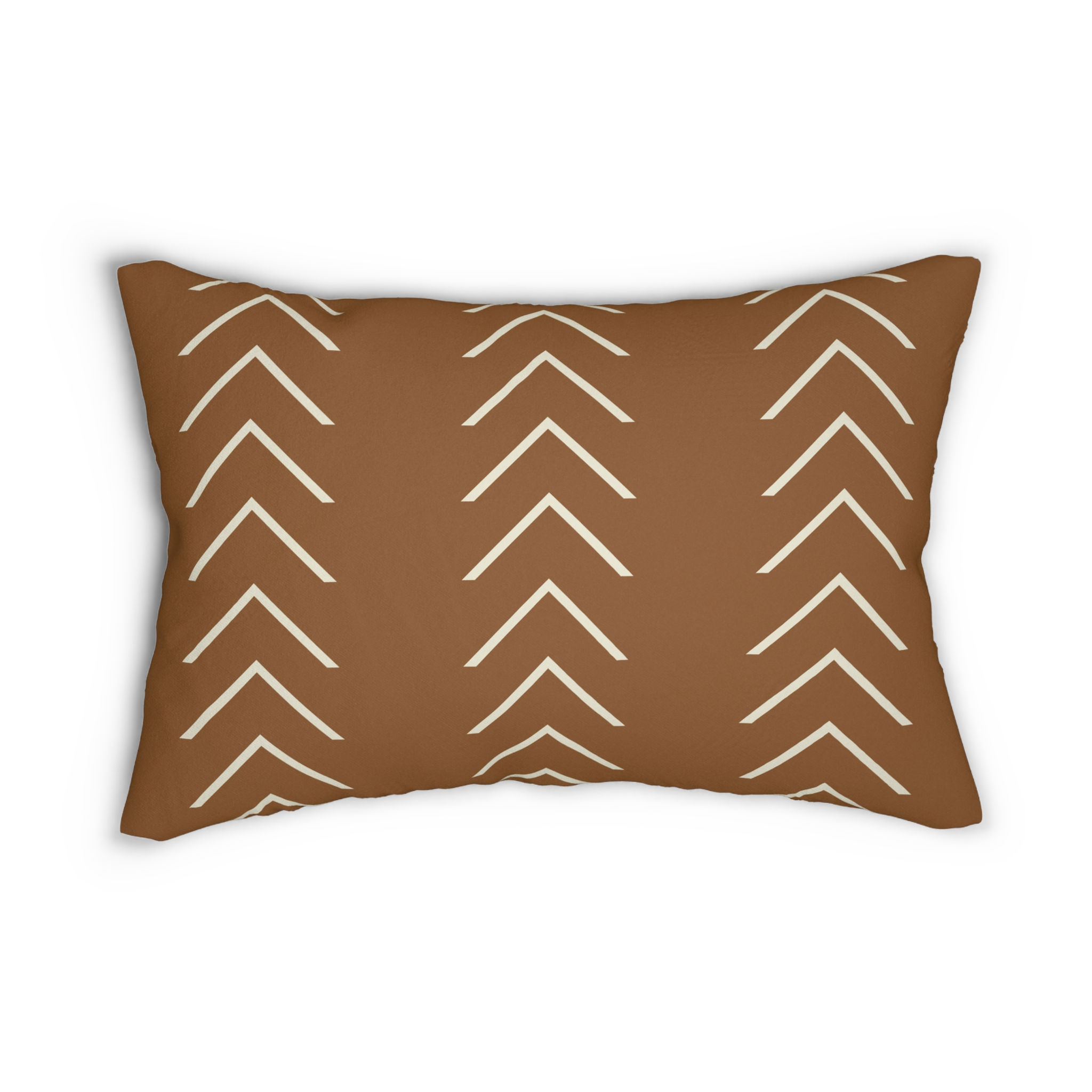 Lumbar cushion with ivory chevron arrow pattern on a rich clay brown background for modern rustic décor.